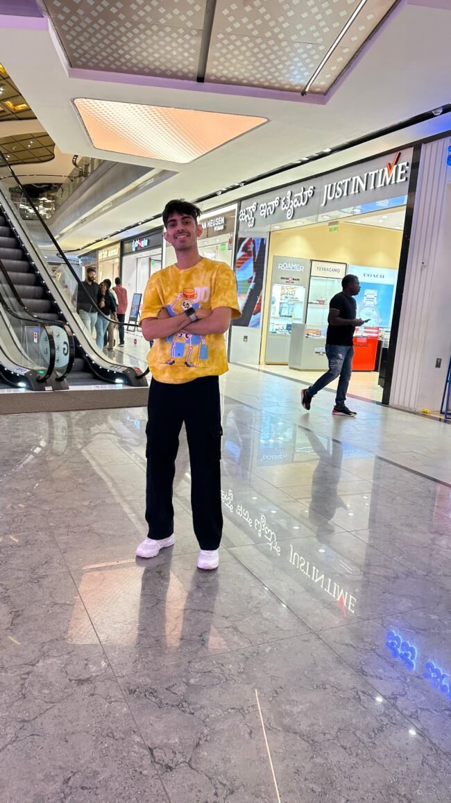 A vibrant yellow oversized tee with a quirky skeleton graphic, playful blue backdrop, and bold streetwear vibes — built for statement looks. Zeal Store Online